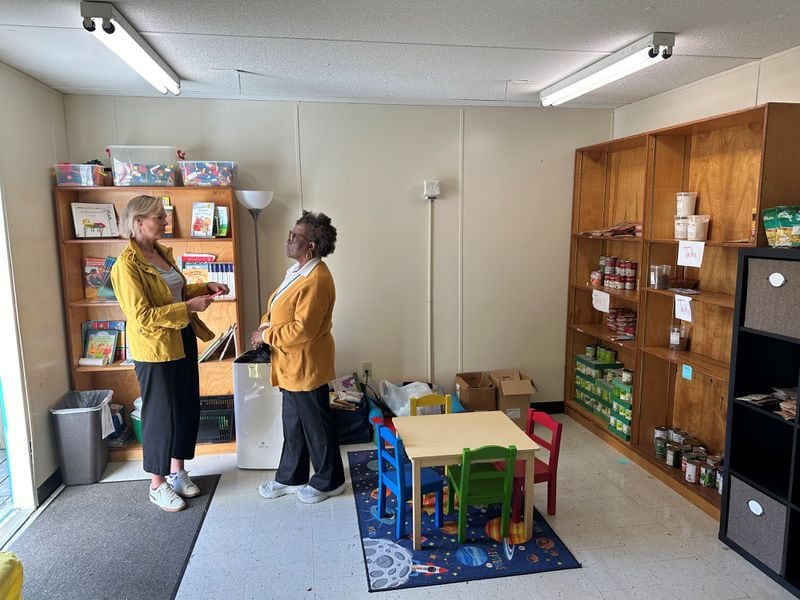 Sue Sullivan (L) and Justine Robinson chat inside the C.A.F.E. at Dunaire Elementary School in Stone Mountain. The C.A.F.E. is a repurposed trailer designed to serve as a resource center for parents and the community which includes immigrant families from at least 29 different countries. Nedra Rhone/nrhone@ajc.com