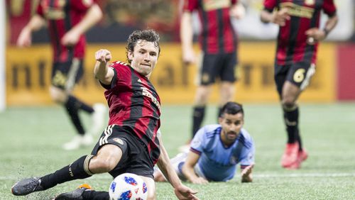 Atlanta United defender Michael Parkhurst (3) slides across the field to kick the ball during the match between NYC FC and Atlanta United Sunday, April 15, 2018, at Mercedes-Benz Stadium in Atlanta.
