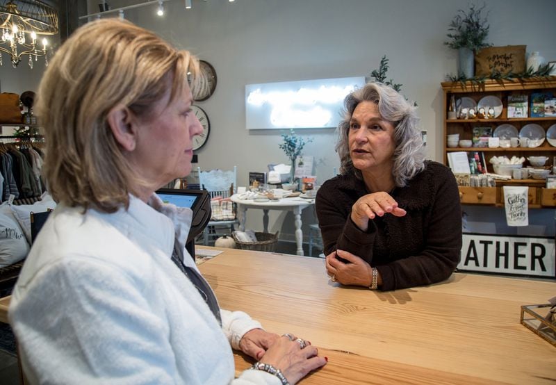 Cheri Morris (right) talks with Kathy Edwards, owner of the Ballog shop, at the new Alpharetta City Center recently. STEVE SCHAEFER / SPECIAL TO THE AJC