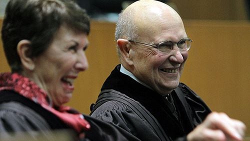 Chief Justice Carol Huntstein (left) and Justice George Carley share a moment of laughter when the honorable Willis Hunt Jr., senior judge, United States District Court of the Northern District, Georgia, delivers the introduction of Justice Carley to a standing room only courtroom.