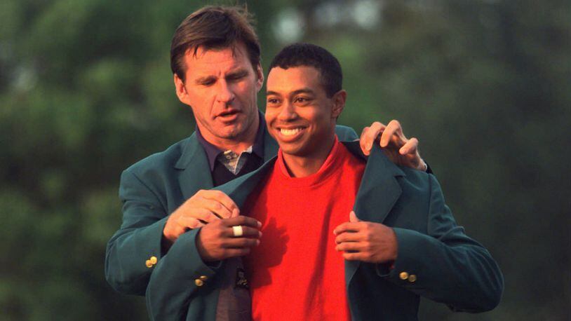 1996 Masters Champion Nick Faldo puts the Green Jacket on 1997 Champion Tiger Woods at the end of the 1997 Masters on Sunday, April 13, 1997. (DAVID TULIS/AJC staff)