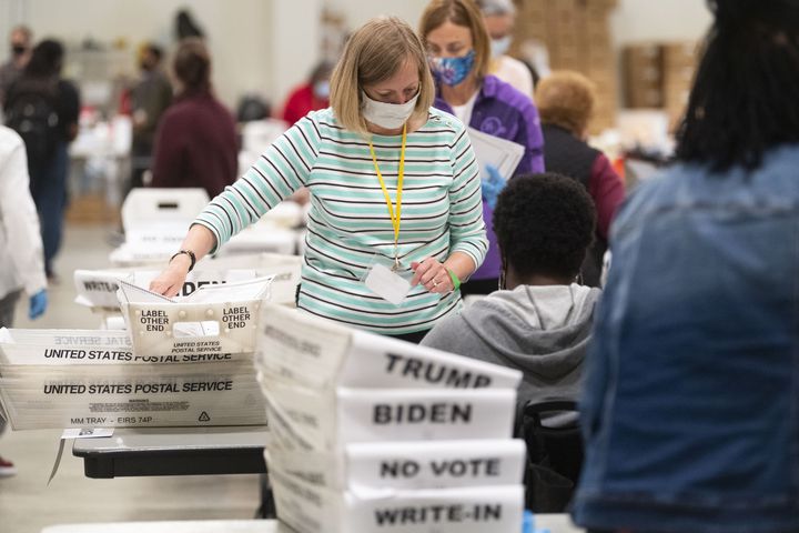An election worker sorts through ballots during a Cobb County hand recount of Presidential votes on Sunday, Nov.15, 2020, at the Miller Park Event Center in Marietta. (JOHN AMIS FOR THE ATLANTA JOURNAL-CONSTITUTION)
