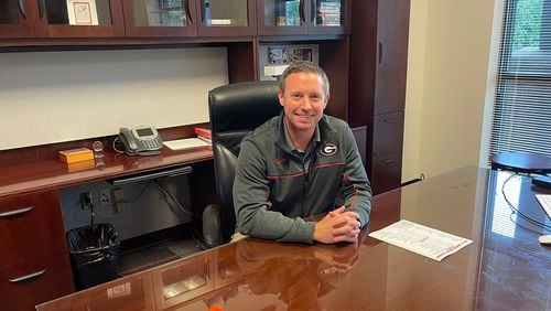 First-year Georgia men’s basketball coach Mike White poses at his desk in his new office at UGA’s Coliseum Training Facility. He hasn’t had much time to decorate since leaving the Florida Gators to become the Bulldogs’ coach on March 13.