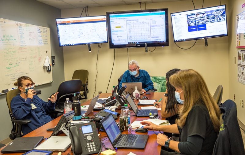 Northeast Georgia Medical Center's incident command center works to keep operations moving as efficiently as possible amid the holiday surge. A hospital official told the AJC that if health insurance companies moved faster processing requests to discharge patients, as many as 25 beds per day within health system could be opened up. (Jenni Girtman for The Atlanta Journal Constitution)