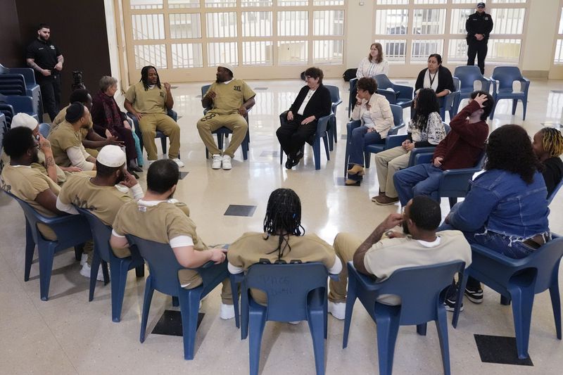 Detainees, DePaul students, and Sister Helen Prejean attend a book club at Department Of Corrections Division 11 in Chicago, Monday, April 22, 2024. DePaul students and detainees are currently reading Dead Man Walking and the author, anti death penalty advocate, Sister Helen Prejean attended to lead a discussion. (AP Photo/Nam Y. Huh)