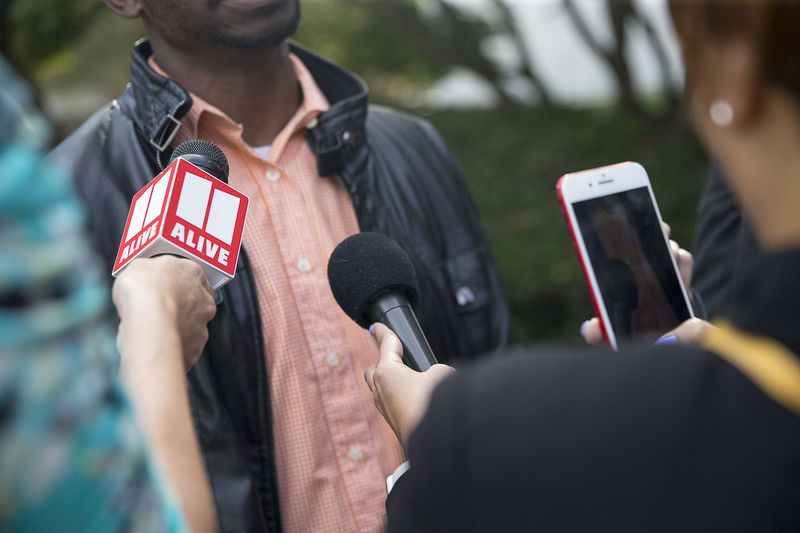 10/14/2019 -- Decatur, Georgia -- Members of the media speak to Juror 31, of the Robert "Chip" Olsen trial, following the verdict in front of the DeKalb County Courthouse in Decatur, Monday, October 14, 2019. Juror 31, a 36-year-old father, asked that his identity be concealed because of the nature of the case. On the sixth day of jury deliberations the jury found Robert "Chip" Olsen not guilty of felony murder. But jurors reached guilty verdicts on four lesser charges: two counts of violation of oath of office, aggravated assault and making a false statement. (Alyssa Pointer/Atlanta Journal Constitution)