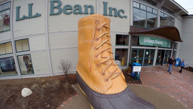 FILE - In this March 16, 2016, file photo, shoppers exit the L.L. Bean retail store in Freeport, Maine.   L.L. Bean is tightening its generous return policy by imposing a one-year limit on most returns to reduce abuse and fraud. Executives say returns of severely worn items have doubled over five years. Under the new policy announced Friday, Feb. 9, 2018, the company will accept returns for one year with a proof of purchase and will continue to replace products for manufacturing defects beyond that. (AP Photo/Robert F. Bukaty, File)