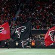 Falcons team members run with Falcons flags celebrating a touchdown during the second half against the New Orleans Saints at Mercedes-Benz Stadium, Sunday, January 9, 2022, in Atlanta. JASON GETZ// THE ATLANTA JOURNAL-CONSTITUTION