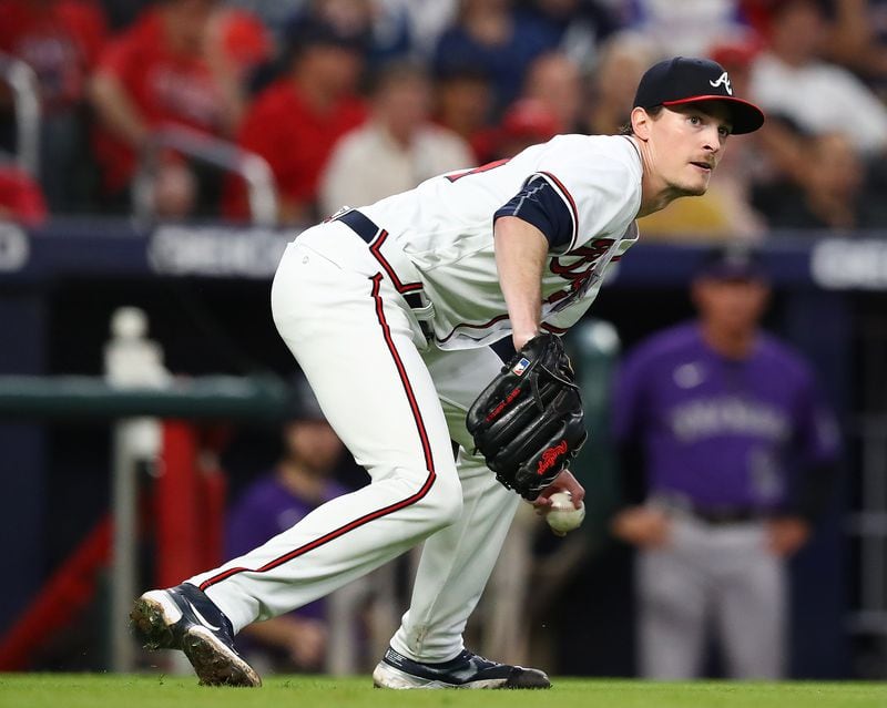 Braves starting pitcher Max Fried slips while fielding a ground ball by Colorado Rockies' Jose Iglesias.   “Curtis Compton / Curtis Compton@ajc.com