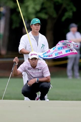 April 9, 2021, Augusta: Hideki Matsuyama and his caddie Shota Hayafuji line up an eagle attempt on the fifteenth hole during the second round of the Masters at Augusta National Golf Club on Friday, April 9, 2021, in Augusta. Curtis Compton/ccompton@ajc.com