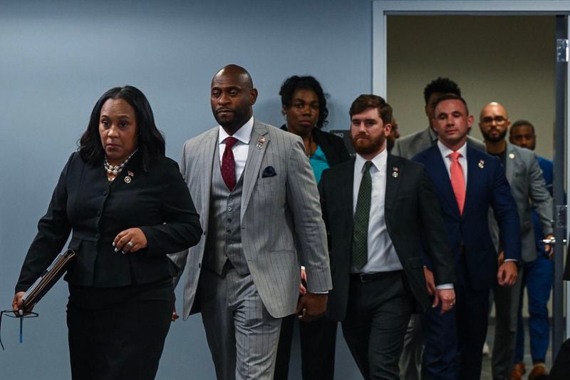 
Fulton County District Attorney Fani Willis, left, is followed by Nathan Wade, who she hired to lead her office’s prosecution of former President Donald Trump, as they arrive at a news conference in Atlanta on Aug. 14, 2023. (Kenny Holston/The New York Times)
                      