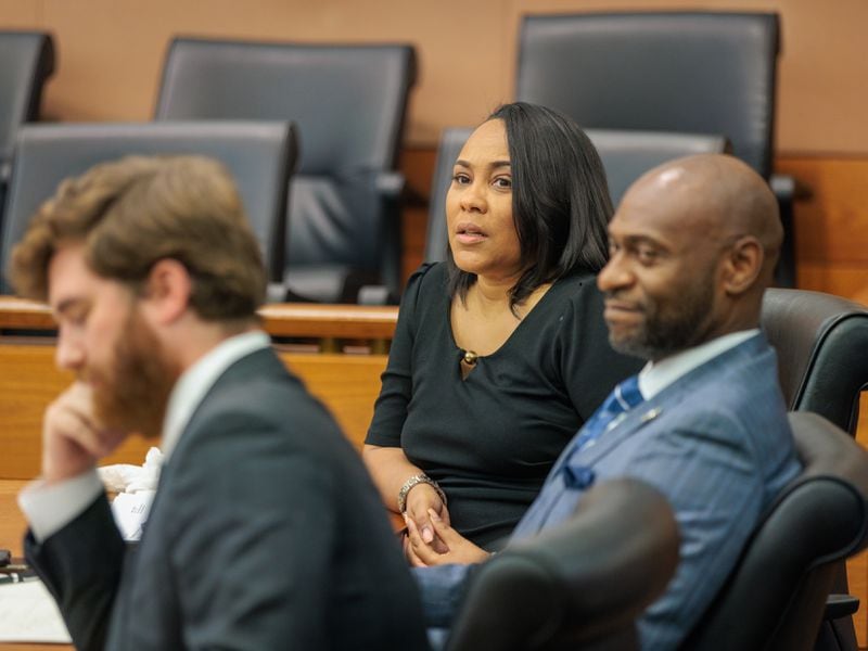 District Attorney Fani Willis (center) reacts to proceedings at Fulton County Superior Court on Thursday, July 21, 2022. (Arvin Temkar / arvin.temkar@ajc.com)