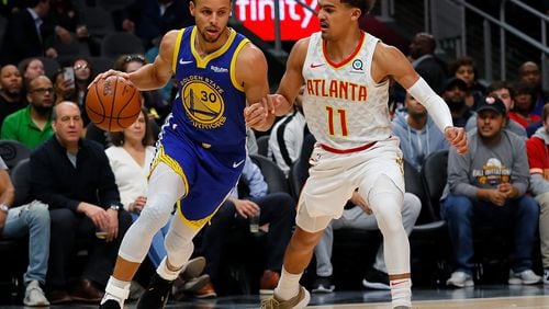 Stephen Curry of the Golden State Warriors drives against Trae Young of the Atlanta Hawks (Photo by Kevin C. Cox/Getty Images)