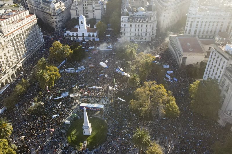 Demonstrators march to the Casa Rosada presidential palace demanding more funding for public universities and to protest against austerity measures proposed by President Javier Milei, in Buenos Aires, Argentina, Tuesday, April 23, 2024. (AP Photo/Natacha Pisarenko)