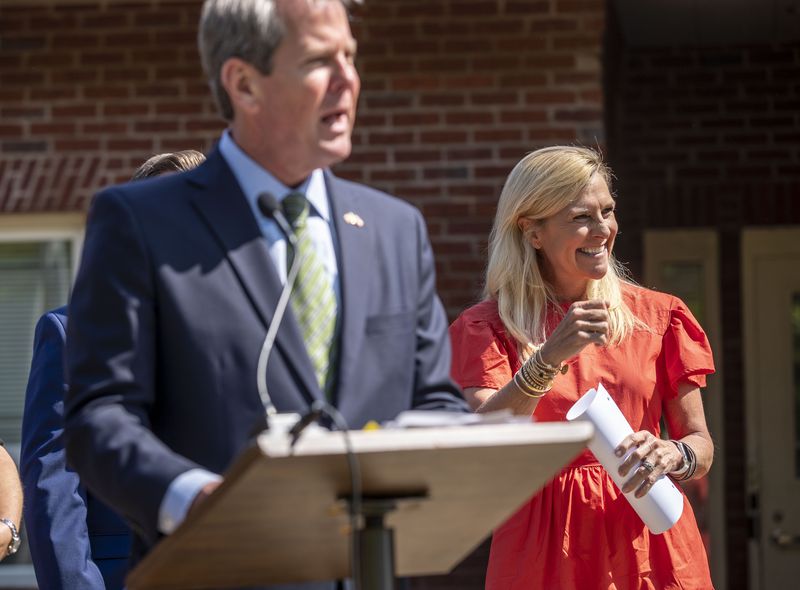 Georgia first lady Marty Kemp smiles as her husband, Gov. Brian Kemp, speaks at a bill-signing ceremony at the Home of Hope in Buford. The governor signed three bills targeting human trafficking that the first lady helped craft. (Alyssa Pointer / Alyssa.Pointer@ajc.com)