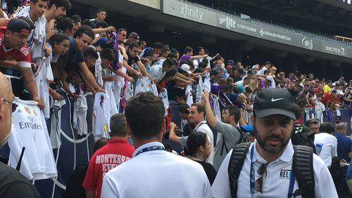 Fans of Real Madrid hang jerseys over the stands in hopes of getting one of the players to sign on Tuesday at Chicago's Soldier Field. Real Madrid will play the MLS All-Stars on Wednesday.