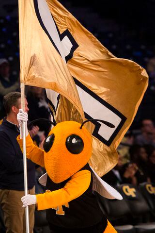 Buzz waves the Georgia Tech flag during a women's basketball game against UGA on Sunday in Atlanta. (CHRISTINA MATACOTTA / FOR THE ATLANTA JOURNAL-CONSTITUTION)
