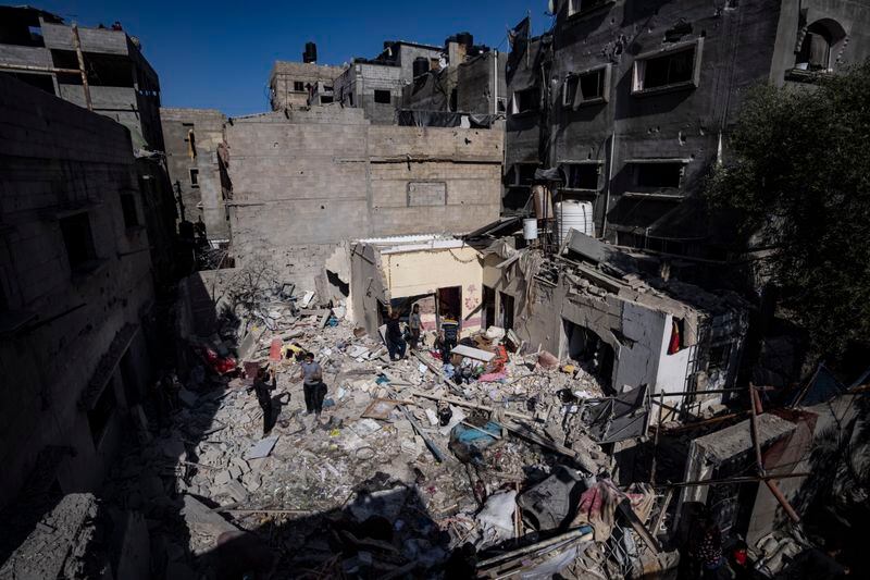 Members of the Abu Draz family inspect their house after it was hit by an Israeli airstrike in Rafah, southern Gaza Strip, Thursday, April 4, 2024. (AP Photo/Fatima Shbair)