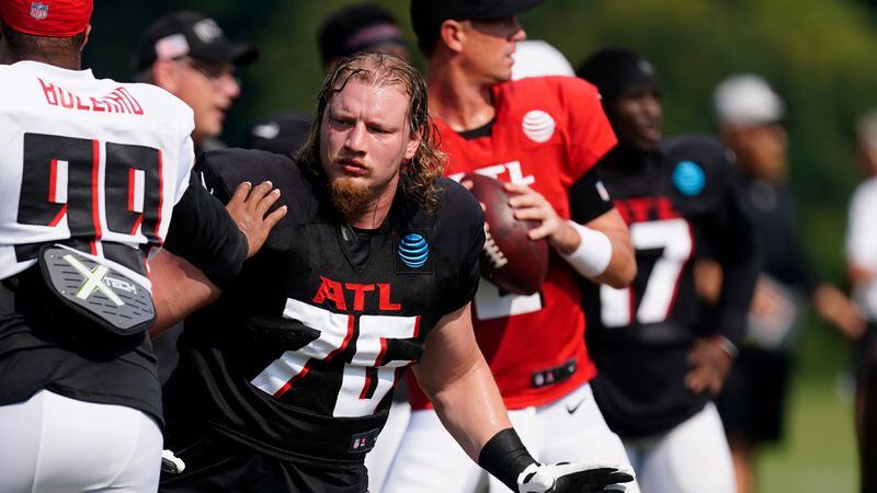 Falcons offensive tackle Kaleb McGary (76) protects quarterback Matt Ryan (background) during the team's practice Monday, Aug. 9, 2021, in Flowery Branch. (John Bazemore/AP)