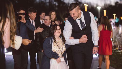 Tim Tebow escorts a young lady to the 2016 Night to Shine event. Photo courtesy of the Tim Tebow Foundation
