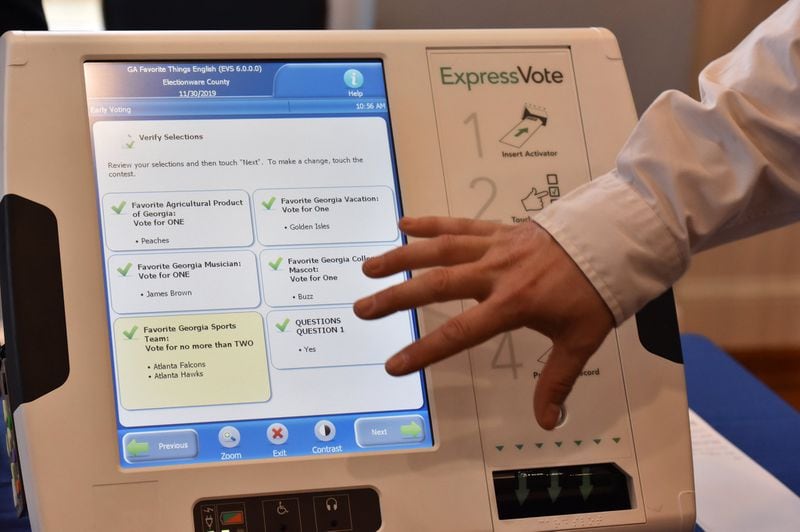 Tobey Dingbaum with Election Systems and Software demonstrates his company’s ballot-marking device voting system at The Depot on Thursday. Election companies demonstrated voting systems to the public and to officials, showing how Georgia could switch to paper ballots. HYOSUB SHIN / HSHIN@AJC.COM