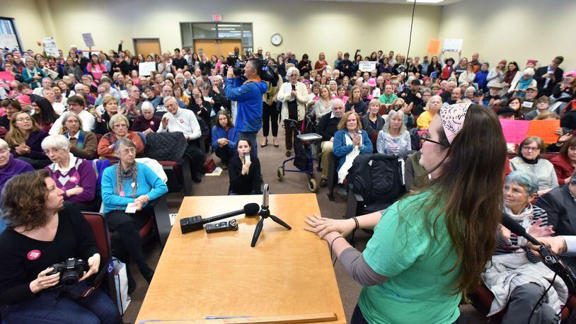 Dr. Michelle Golden (foreground) speaks at a congressional event that turned into a stand against Donald Trump's policies in Greensboro. HYOSUB SHIN / HSHIN@AJC.COM