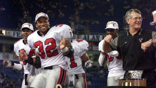 Falcons coach Dan Reeves (right) does the "Dirty Bird" with players Jamal Anderson (32) and Ray Buchanan after accepting the NFC trophy In January 1999. (David Tulis/Atlanta Journal-Constitution/TNS)
