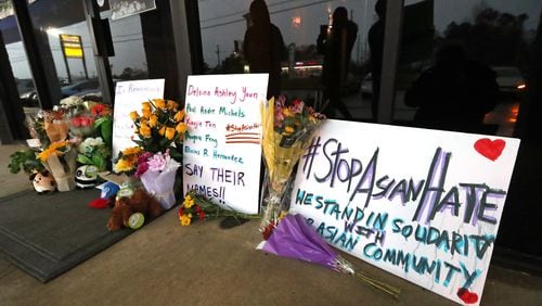 A memorial grows larger by the hour outside Young’s Asian Massage, where four people were killed on Wednesday, March 17, 2021, in Acworth. At least eight people were found dead at three different spas in the Atlanta area March 16. Robert Aaron Long, 21, was charged in the shooting spree, which began at Young’s Asian Massage. (Curtis Compton / Curtis.Compton@ajc.com)