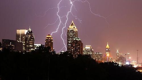 Lightning strikes behind the Atlanta skyline in a 2020 photo. A teenager swimming off Tybee Island is among the first two people killed by lightning this year in the U.S.