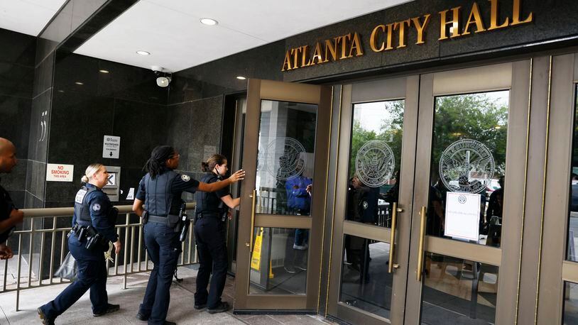 Atlanta Police officers walk into The City Hall to help with security as the Council is set to approve legislation that funds the training center on Monday, June 5, 2023.Miguel Martinez /miguel.martinezjimenez@ajc.com