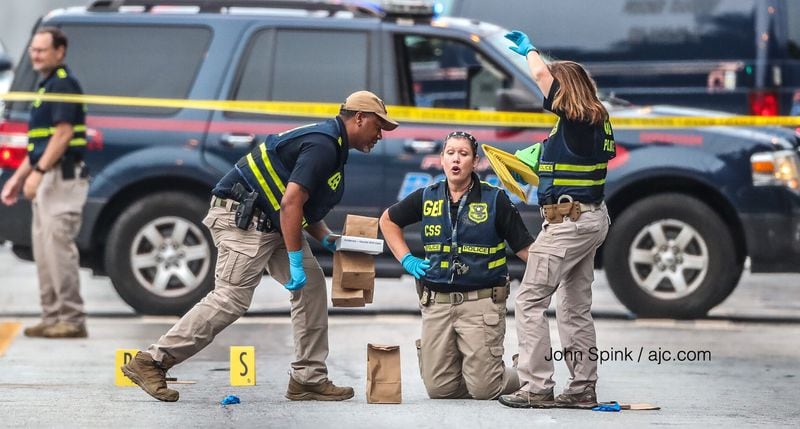 GBI and Atlanta police investigators were on the scene of an officer-involved shooting in downtown Atlanta on Friday morning. JOHN SPINK / JSPINK@AJC.COM