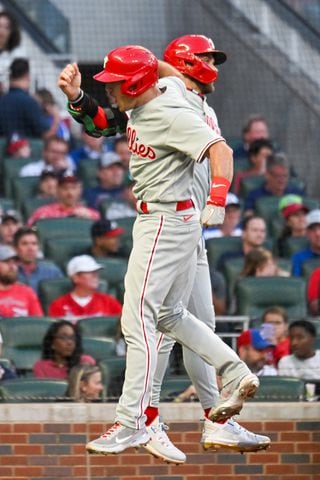 Philadelphia Phillies catcher J.T. Realmuto (L) celebrates a two-run home run against the Atlanta Braves during the third inning of the NLDS Game 2 in Atlanta on Monday, Oct. 9, 2023.   (Hyosub Shin / Hyosub.Shin@ajc.com)
