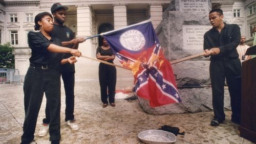 Burning Georgia's "racist past" is how Lawrence Jeffries (right) described the flag-burning Sunday at the Capitol. From left are the Ina Solomon, Jeffery Harris and Stacey Abrams in June 1992. (W.A. Bridges Jr./The Atlanta Journal-Constitution)
