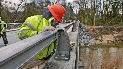 A construction worker works on the Peachtree Dunwoody bridge over Nancy Creek on March 23, 2010. John Spink, jspink@ajc.com