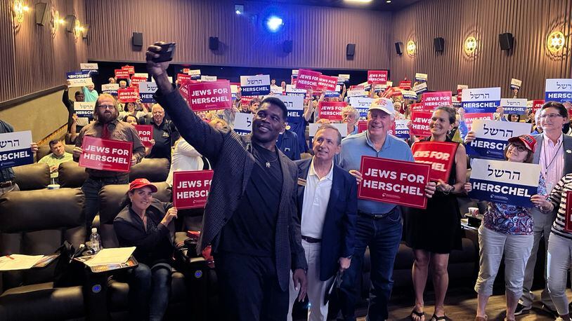 Republican Senate hopeful Herschel Walker takes a selfie at a Republican Jewish Coalition event on Aug. 21, 2022 in Sandy Springs. 