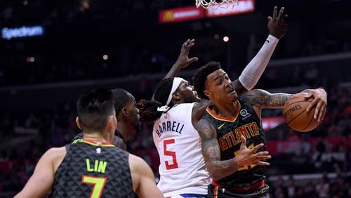 John Collins of the Atlanta Hawks takes a rebound from Montrezl Harrell of the LA Clippers during a 123-118 Hawks win at Staples Center on January 28, 2019 in Los Angeles, California. (Photo by Harry How/Getty Images)