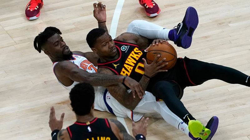 New York Knicks center Mitchell Robinson (23) battles Atlanta Hawks guard Brandon Goodwin (0) for the ball during the first half of Monday's game in Atlanta.