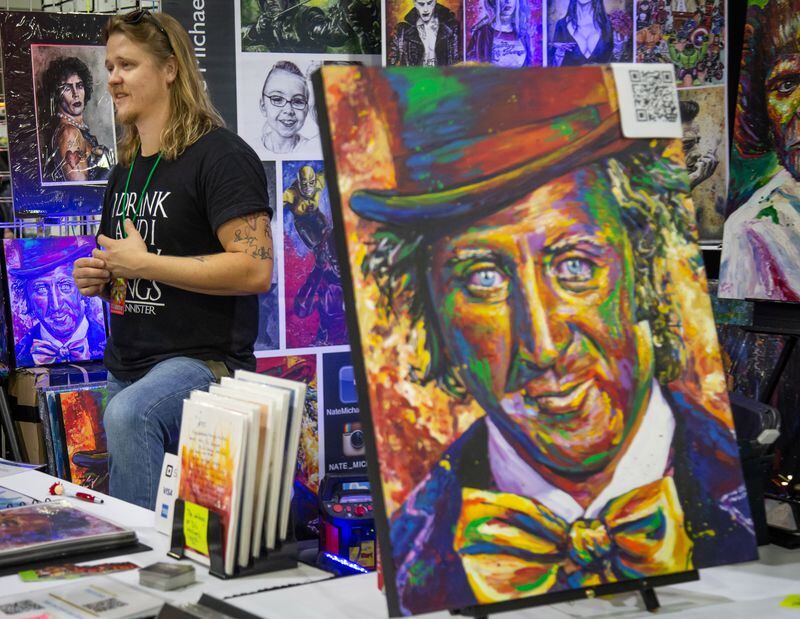 Artist Nate Michaels talks with customers at his vendor booth during the Atlanta Comic Con on Sunday, July 15, 2018, in the Georgia World Congress Center. (Photo: STEVE SCHAEFER / SPECIAL TO THE AJC)