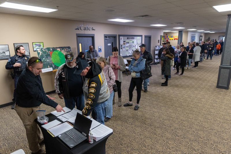 People wait in line for assistance from Norfolk Southern at Abundant Life Fellowship church in New Waterford, Ohio on Friday, February 17, 2023. (Arvin Temkar / arvin.temkar@ajc.com)