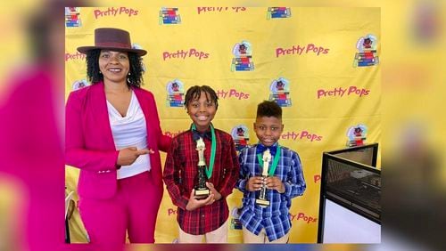 Treandos (middle) and Noah Thornton (right) are pictured with Andrea Carter, founder of the I AM Black History Awards Brunch, which highlights the efforts of Black youths who have made a significant impact in their communities. (Handout)