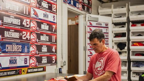 Zac Walsh, inside the Atlanta Hawks laundry room, with name plates from past players taken on Saturday, March 30, 2024, in Atlanta, at State Farm Arena. (Atlanta Journal-Constitution/Jason Allen)