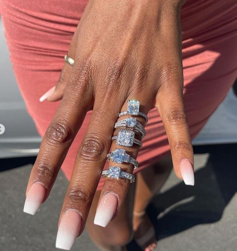 Brittney Miller shows off all five diamond rings William Hunn used to propose.