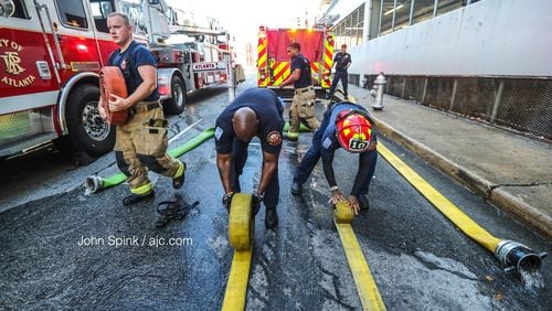 Atlanta firefighters respond to a fire at a parking deck on Decatur Street in downtown Atlanta on Tuesday morning.