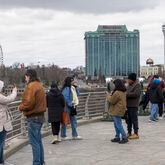 Tourists on the American side of Niagara Falls take photos in Niagara Falls, N.Y. on Friday, March 29, 2024. Ontario's Niagara Region has declared a state of emergency as it readies to welcome up to a million visitors for the solar eclipse on April 8. (Carlos Osorio/The Canadian Press via AP)