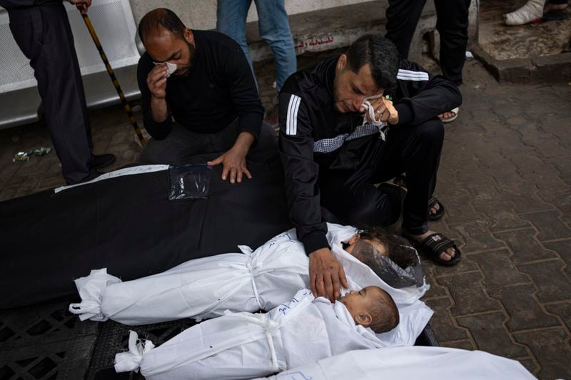 Members of the Abu Draz family mourn their relatives killed in the Israeli bombardment of the Gaza Strip, at a hospital morgue in Rafah, southern Gaza Strip, Thursday, April 4, 2024. (AP Photo/Fatima Shbair)