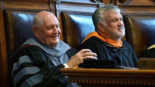Sonny Perdue, chancellor of the University System of Georgia, smiles as he sits with Georgia Board of Regents Chairman Harold Reynolds during Perdue's investiture ceremony in September. The regents recently elected Reynolds to serve another year as its leader. (Hyosub Shin / AJC FILE PHOTO)