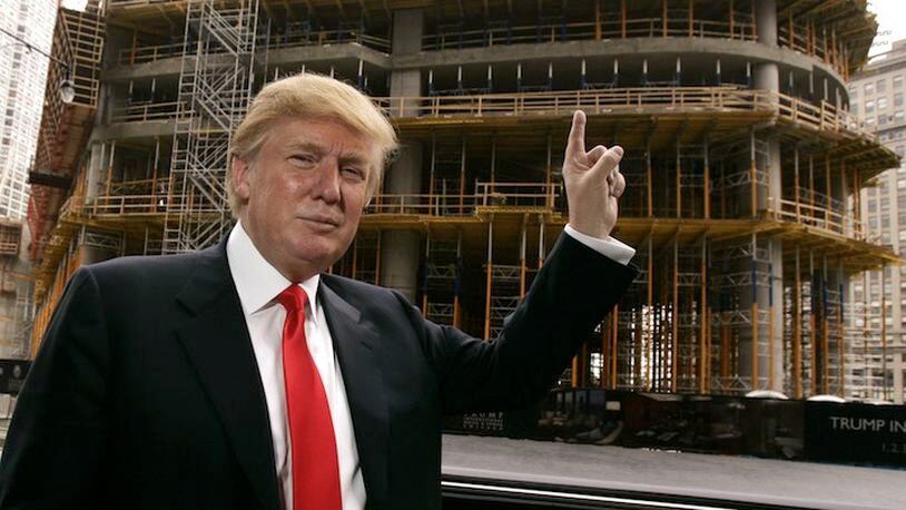 In this April 10, 2006, file photo, Donald Trump poses outside his Chicago offices and his 92-story residential tower underconstruction on the Chicago River. There's something about bulldozers and hard hats that brings a family together. It worked for Donald Trump and his father. And it worked for Donald Trump and his children. (AP Photo/Charles Rex Arbogast, File)