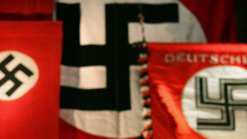 A Nazi flag, reportedly hung for a history lesson, remained in the window of a public school classroom over the weekend. Many took to Facebook to express their outrage and confusion.