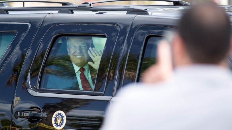 President Donald Trump waves as he travels down Southern Boulevard to Palm Beach International Airport on April 16 after spending Easter weekend in Palm Beach. Trump (Allen Eyestone / The Palm Beach Post)