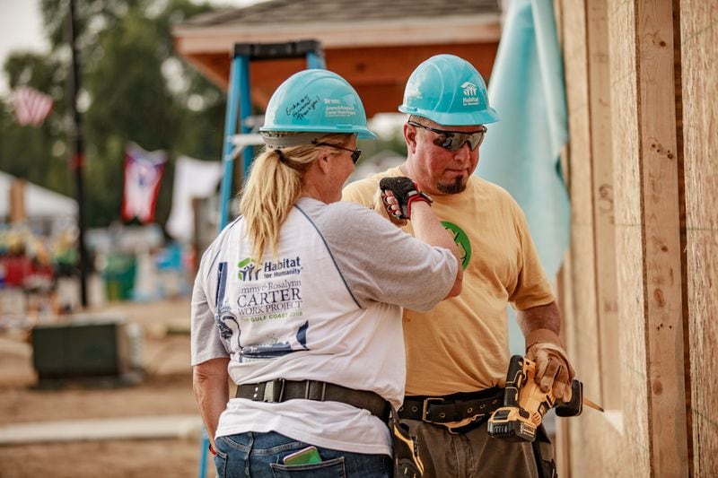 Garth Brooks and Trish Yearwood fist bump while working, Tuesday, at the 2018 Habitat for Humanity Jimmy and Rosalynn Carter Work Project in St. Joseph County, Indiana, Tuesday August, 28th, 2018.